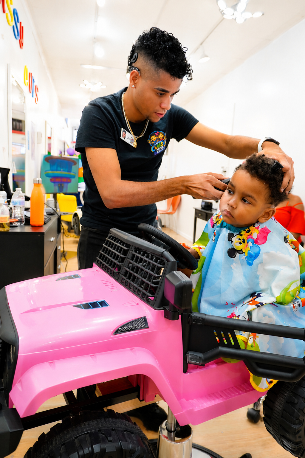 Barber trimming a young boy's hair in the salon